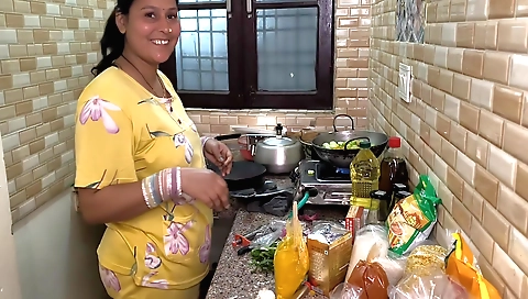 Indian chick cooking with her friend in the kitchen