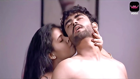 A sexy brunette is in the studio wearing a sexy blouse