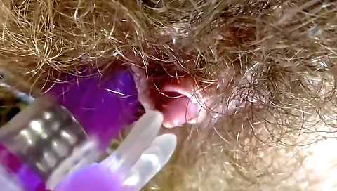 Amateur solo girl with a hairy vagina plays with a toy