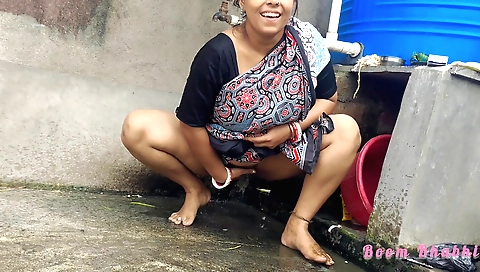 Naked brunette enjoys peeing in the big bowl outside