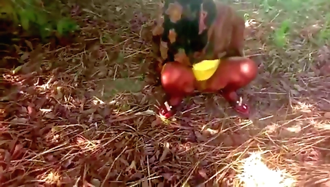 Red dress and stockings naked solo girl in an outdoor setting